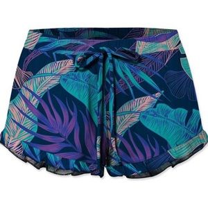 Ruffle hem drawstring shorts in blue leaf pattern.